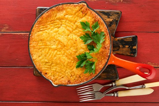Sweet Potato Shepherds Pie in a skillet with a red background